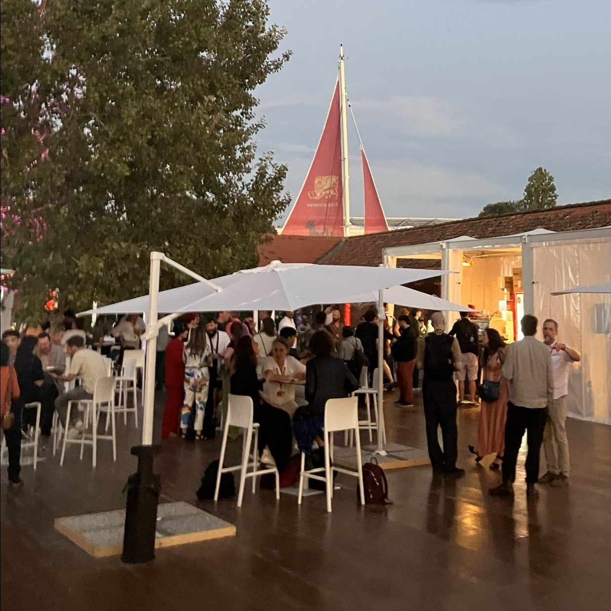Professionals socializing around the café courtyard at Venice Immersive.