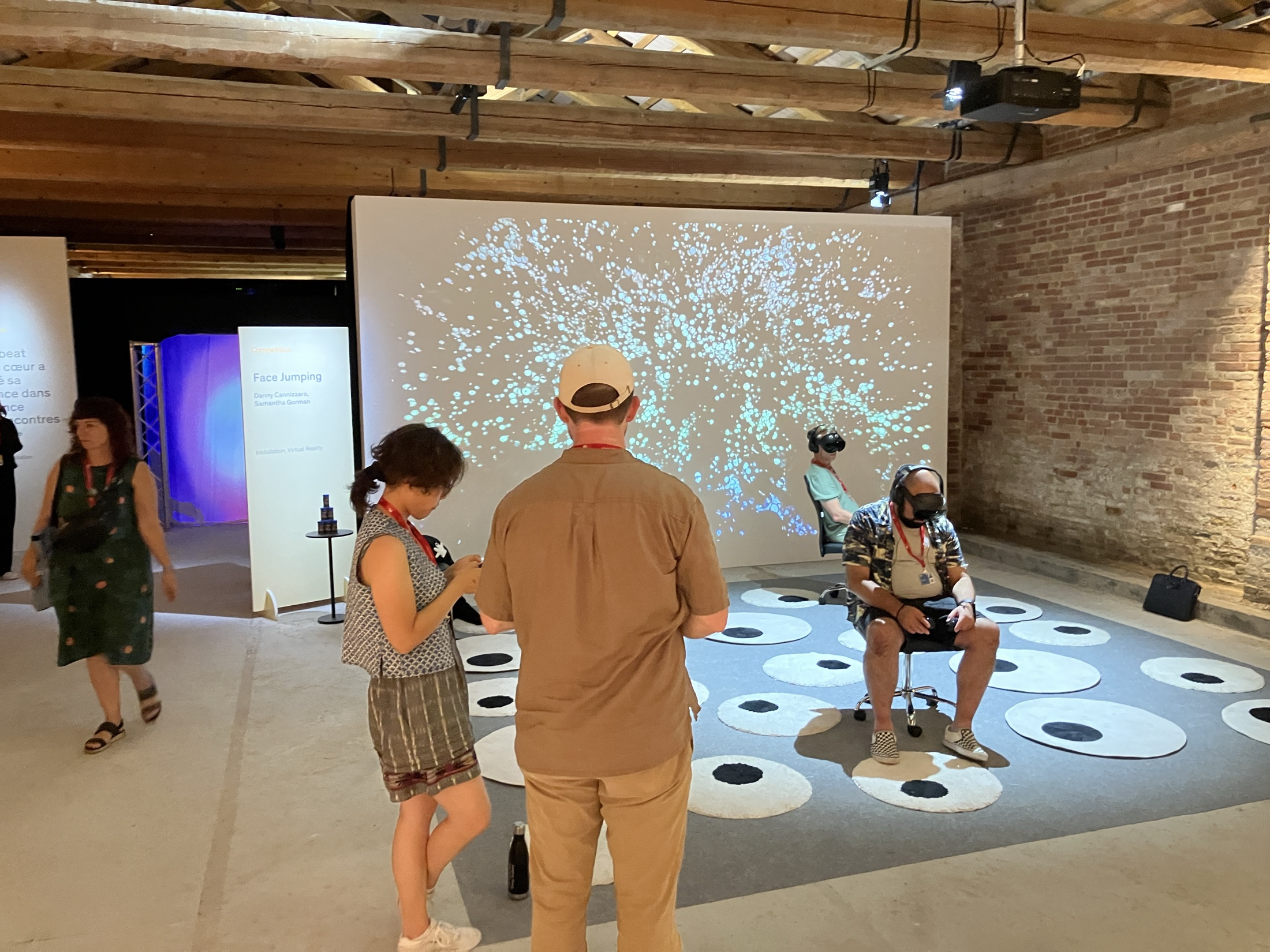 Visitors using VR headsets inside a designed immersive installation.